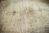 Distressed vintage Sparta carpet with softened ivory, beige, and navy medallion patterns.