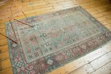 Distressed Sivas rug corner, faded raspberry pomegranate border, sea foam green field.