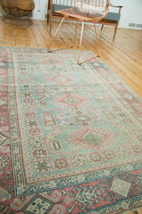 Distressed Sivas rug's soft geometric pattern in faded sea foam green and wine red.