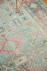 Evenly worn texture and geometric motifs in sea foam green, faded raspberry, and ivory.