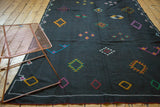 Black Moroccan Kilim with embroidered diamond shapes in fuchsia, aqua, and saffron yellow.