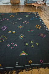 Vintage Moroccan Kilim with jet black field, vibrant diamond-shaped embroidery, and fringe.