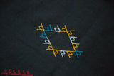 Moroccan Kilim rug with embroidered diamond motif in aqua blue, white, saffron, and red.