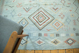 Geometric Moroccan Kilim rug with serrated concentric diamonds in pale blue and terra cotta.