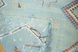 Embroidered serrated diamonds on a pale blue Moroccan Kilim with textural threads.