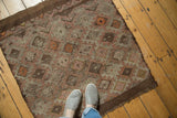 Vintage Turkish Jijim rug corner with geometric diamond panels and asymmetric color fills.