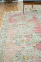 Distressed Oushak rug texture with soft blush, dusty gold, and seafoam abrash.