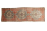 Vintage Distressed Oushak runner with triple scalloped medallions in cinnabar red and muted tones.