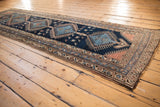 Border detail of vintage Kurdish runner, with beige, sky blue, and terra cotta motifs.