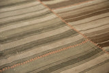 Hand-woven Moroccan Kilim patchwork seam with contrasting stitch detail and earthen stripes.