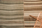 Hand-woven Moroccan Kilim patchwork rug, showing stitched joining of striped panels.