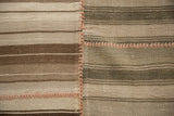 Horizontal ivory, brown, and wooded stripe patterns joined by a rustic hand-stitched seam.