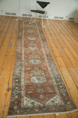 Distressed Malayer runner corner with copper, powder blue medallions, and dark teal palmette border.