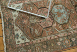Distressed vintage Malayer rug showing worn copper, blush, and powder blue palmette patterns.