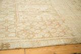 Distressed texture and geometric guls on a vintage Oushak rug in sand and blush tones.