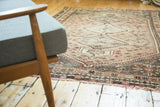 Distressed fringe and barber pole border of a vintage Shiraz carpet.
