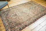 Distressed Shiraz carpet edge, faded madder root red fringe, striped barber pole border.