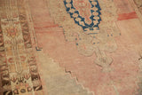 Low pile and textured distress on a dusty rose and beige vintage Oushak rug detail.