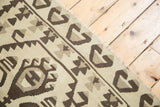 Hand woven distressed Turkish Kilim showing geometric tree of life motif, ivory, charcoal, silver.