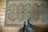 Antique distressed Malayer rug with allover lattice henna plant motif, showing wear and exposed foundation.