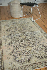 Distressed patina and intricate henna plant motifs on this antique Malayer rug.