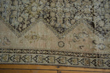 Antique distressed Malayer rug border with geometric motifs and worn pile showing exposed foundation.