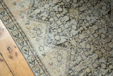 Antique Malayer rug detail, showing distressed pile, exposed foundation, and faded henna motif.