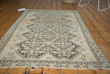 Worn henna lattice motif and visible foundation on an antique distressed Malayer rug corner.