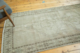 Distressed vintage Oushak runner's minimalist medallion, featuring neutral tone-on-tone color and even wear.