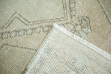 Distressed Oushak rug pile shows even wear, neutral tones, and hand-knotted foundation.
