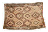 Vintage Turkish Kilim rug with geometric diamond medallions in earthy neutral tones, 4'3