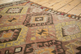 Hand woven Turkish Kilim texture with pale saffron, blush, and chocolate diamond motifs.