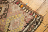 Close-up of vintage Turkish hand-woven Kilim rug, flatweave texture, fringe, geometric patterns.