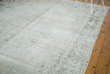 Distressed Oushak carpet pile, showing even wear, visible foundation, and soft floral motifs.