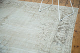 Faded texture and visible foundation of a distressed Oushak carpet.