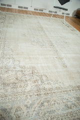 Distressed Oushak rug, showing worn knot heads, visible foundation, and faded floral motif.