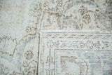 Distressed vintage Oushak carpet fringe and worn pile showing foundation, in ivory and pale coffee.