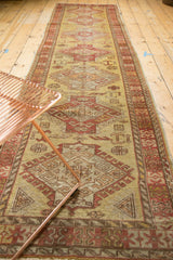 Vintage Oushak rug runner from an angled perspective showing its length and geometric pattern.