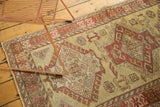 Textured low pile of a vintage Oushak runner showing serrated leaf and ram's horn motifs.