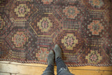 Textured vintage Jijim rug with faded geometric panels and subtle color variations.