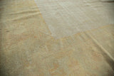 Distressed antique Oushak pile texture, revealing rewoven foundation, knot heads, ivory, and gold tones.