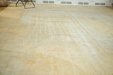 Overall distressed texture of antique Oushak rug in soft ivory, sand, and faded gold tones.