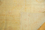 Antique Oushak rug pile with rewoven areas, fringe, and hand-knotted foundation.