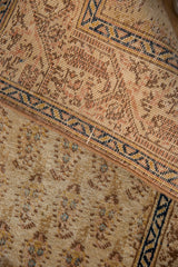 Low pile of vintage Tabriz runner, featuring muted beige Mir cyprus and navy Serbend patterns.