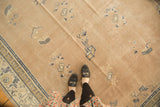 Pale mauve distressed Chinese carpet, scattered pictorial motifs, and a blue arts and crafts border.