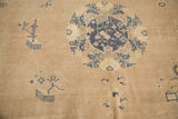Pictorial cobalt blue roundel medallion and scattered symbols on distressed antique Chinese carpet.