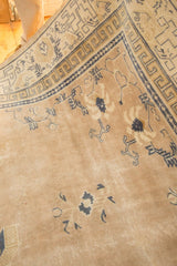 Antique distressed Chinese rug corner with unique 'running T' border and cobalt blue motifs.