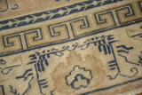 Distressed antique Chinese carpet border, cobalt blue running T pattern, arts and crafts motifs.