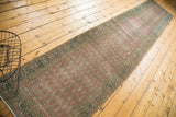 Distressed vintage Tabriz runner with faded blush Mir cyprus tree pattern and border.
