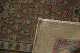 The woven camel hair foundation and hand-knotted pile of an antique Persian Serab rug runner.